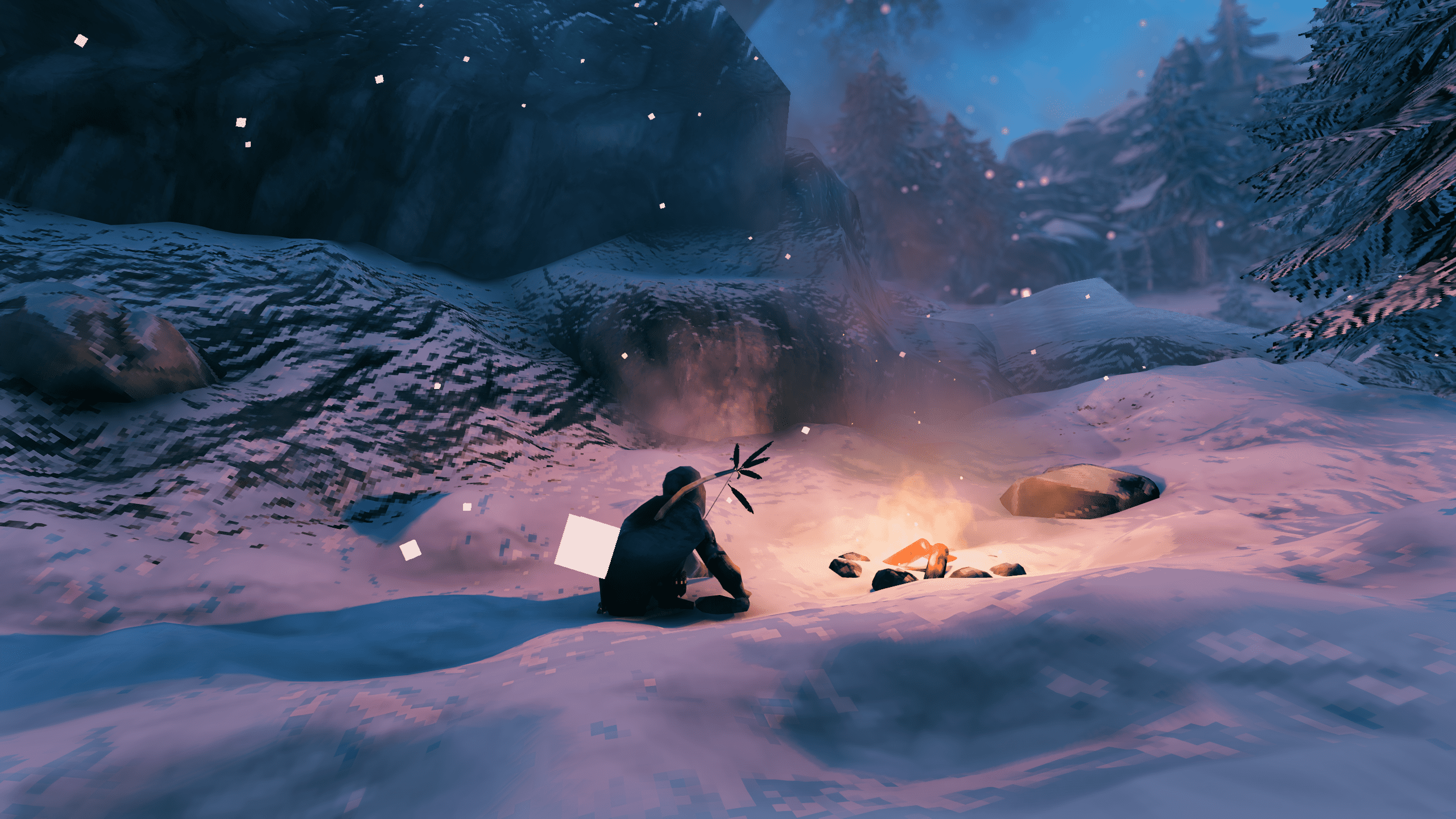 Postava Valheima odpočívá u táboráku ve sněhu