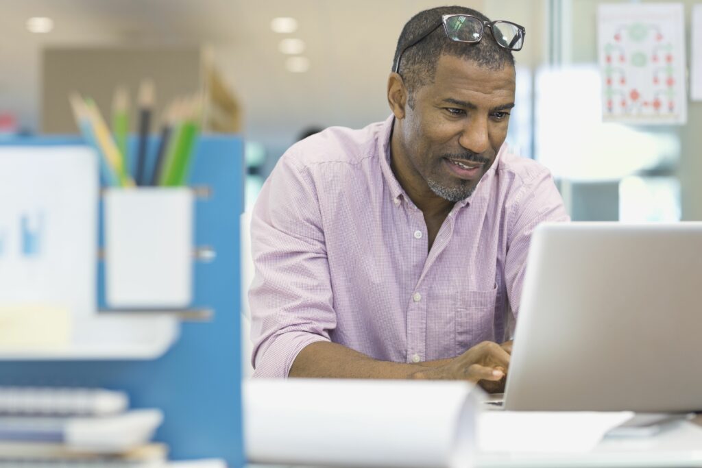 businessman using laptop at office desk 463028797 5a39c567482c52003617c420