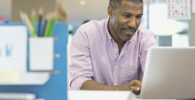 businessman using laptop at office desk 463028797 5a39c567482c52003617c420