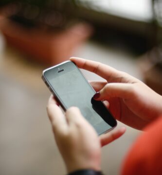 close up shot of hands using handphone 498204000 5748808a5f9b58516511494d