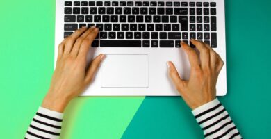 cropped hands of woman using laptop over colored background 1053740888 5be1cdc846e0fb002636ad37