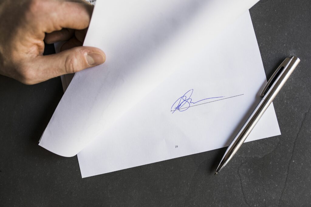 cropped image of businessman holding document with signature 723515191 593defc85f9b58d58a33d3ad