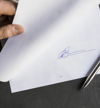 cropped image of businessman holding document with signature 723515191 593defc85f9b58d58a33d3ad