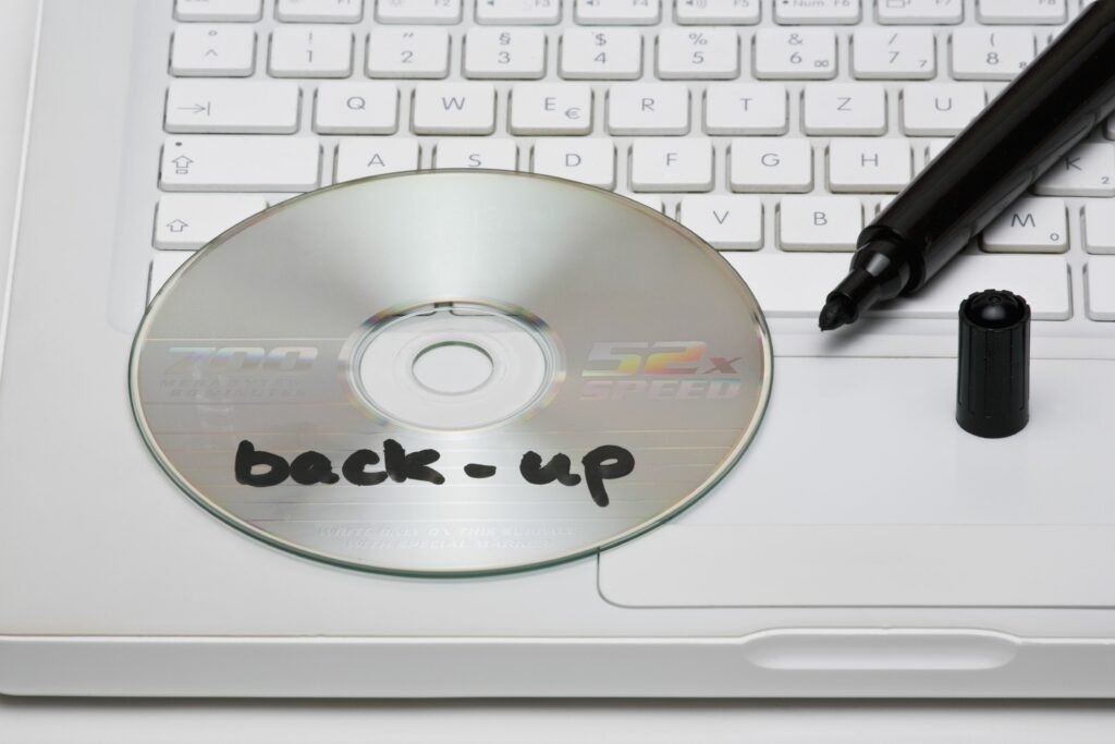 detail of a back up disc and a marker on a laptop 101883221 5b9f80c1c9e77c002cd5aa91