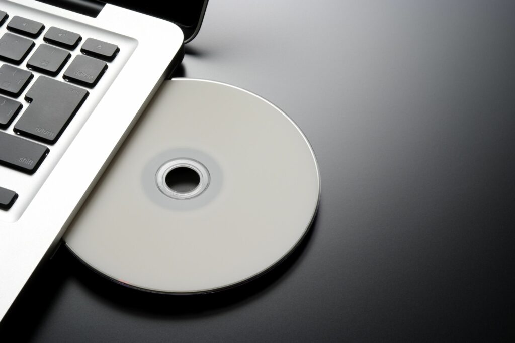 inserting a blank cd into a laptop with copy space 183334872 57c368ca3df78cc16eb343cb