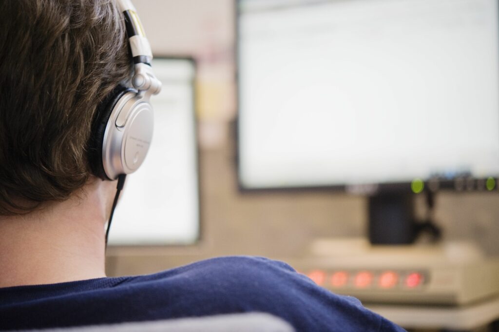 man listening to headphones at work 83211476 57c716e75f9b5829f446ca58