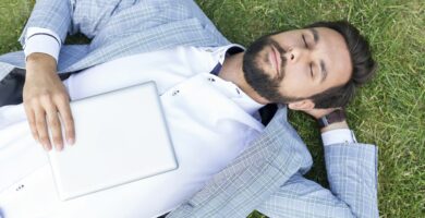 man lying on lawn with closed eyes holding digital tablet 590773539 5b47a26a46e0fb00549a0009