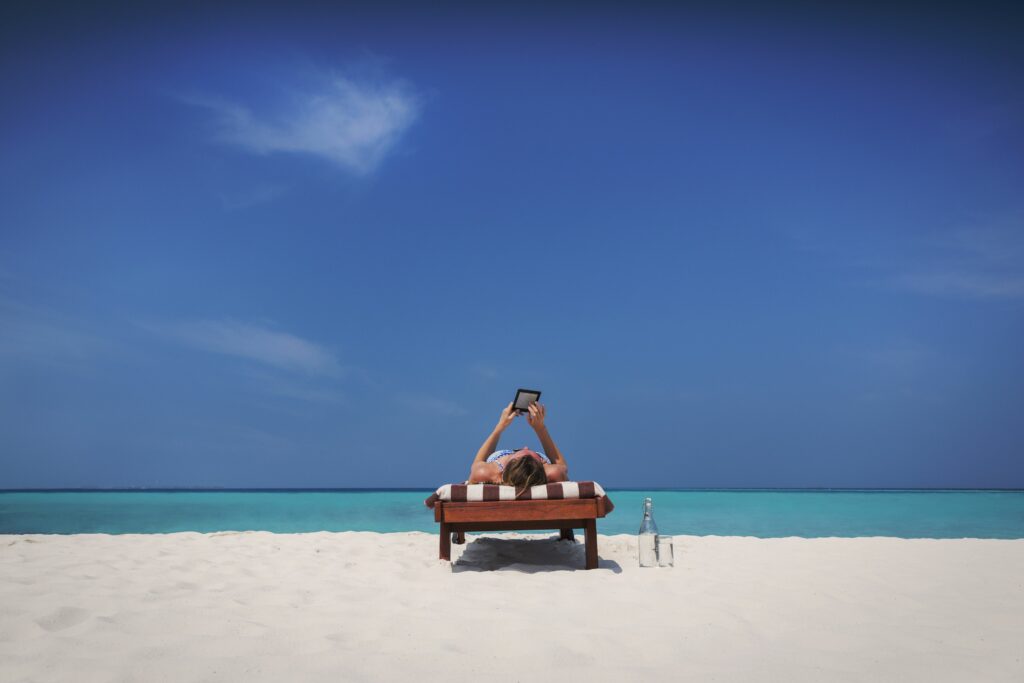 woman relaxing sunbathing laying on lounge chair and using digital tablet on sunny tropical beach 730132809 5b183367ff1b780036d7fd5b