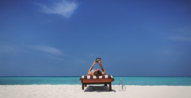 woman relaxing sunbathing laying on lounge chair and using digital tablet on sunny tropical beach 730132809 5b183367ff1b780036d7fd5b
