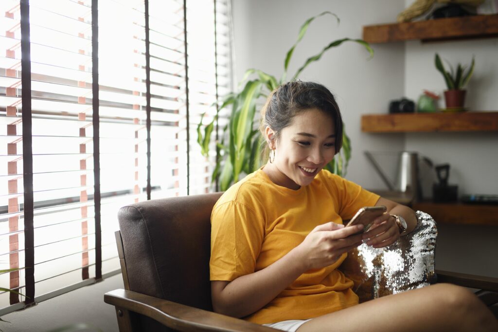 woman using her smart phone at home 1150618333 7ebe48d358554af78a6fede9e8903959