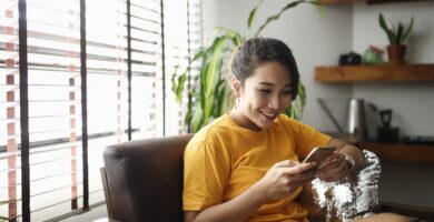 woman using her smart phone at home 1150618333 7ebe48d358554af78a6fede9e8903959