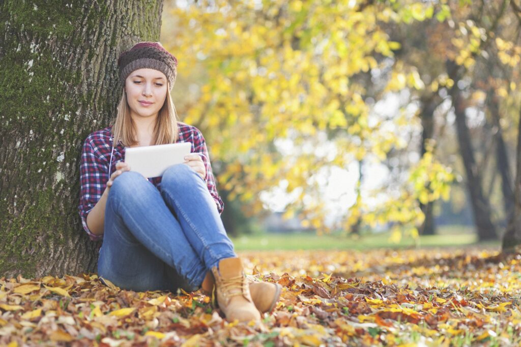 young girl in the park using her tablet pc 523033389 5be06900c9e77c00269007a5