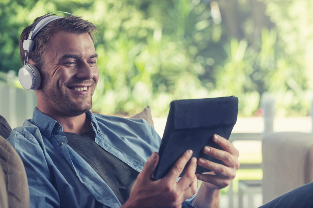 young man listening to music with a digital tablet 504222904 5b27623e119fa80036547693