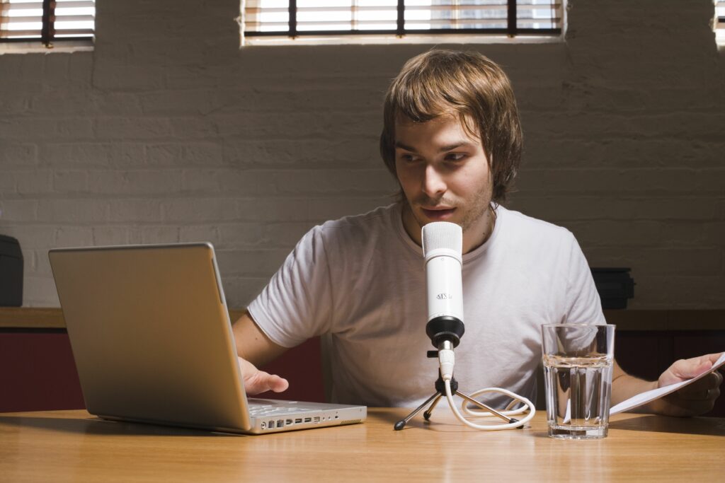 young man with laptop and microphone indoors 200498095 001 5b22b19ceb97de0036f1e19b