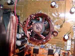 Chladicí ventilátor CPU zarovnaný přes montážní otvory základní desky.