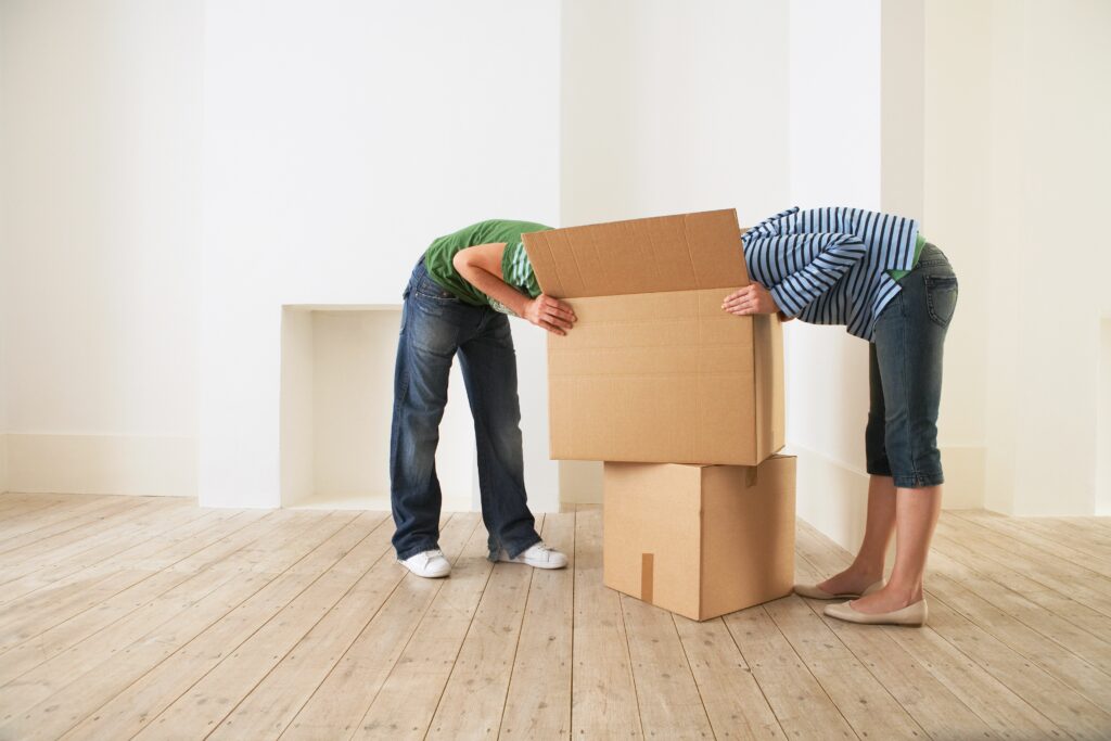 1889405 Young couple unpacking box in new home with faces hidden 58c921513df78c353c69939b