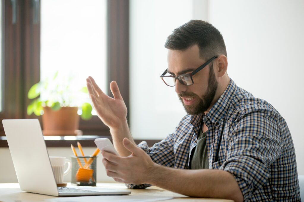 angry bearded businessman annoyed with phone call in office 889206802 5aec6f4704d1cf0037b64c01