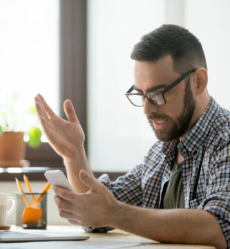 angry bearded businessman annoyed with phone call in office 889206802 5aec6f4704d1cf0037b64c01