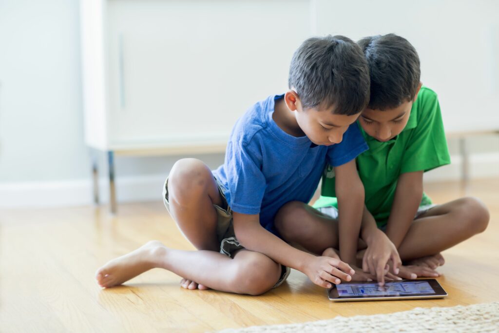 boys using digital tablet on floor 187138181 58b522e75f9b586046eca157