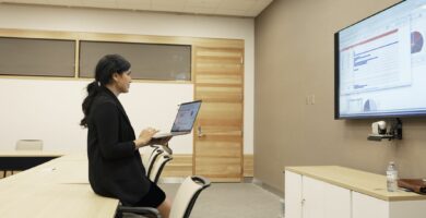 businesswoman preparing audio visual presentation in conference room 1089100558 d1a5f943200f450c93ddaf72966f2954