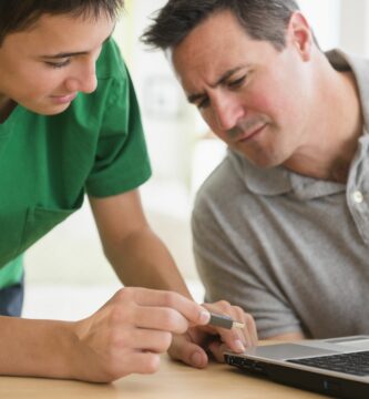 caucasian son showing father how to use usb stick in laptop 482143309 5b78d1a646e0fb002ce0da43