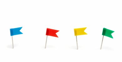 close up of colorful flag shape thumbtacks over white background 1067551886 2ba73088d7444285b0f9440462fdbeea