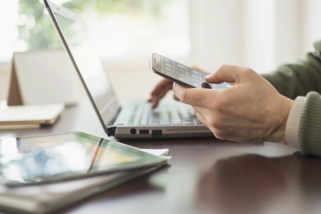 close up of mans hands working at desk with electronic devices 555173169 573f138a5f9b58723de8bfe1