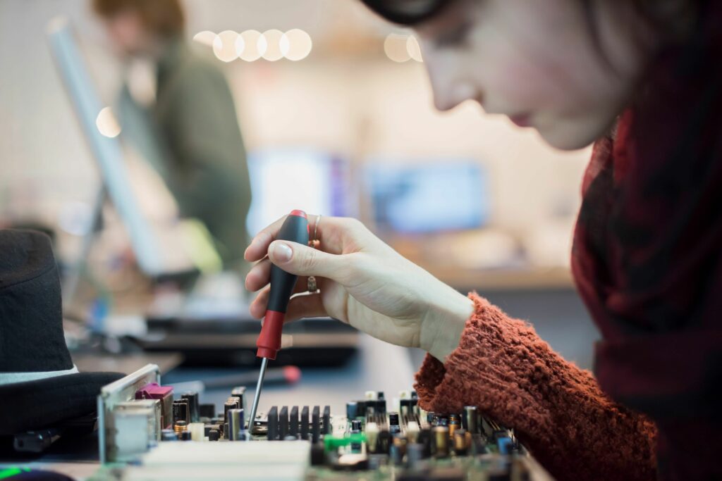 computer repair shop a woman using an electronic screwdriver tool on a computer circuit board 546999517 57a25f453df78c32762ad89e be9dc32d96f14b1196bed2ccbb07d88d