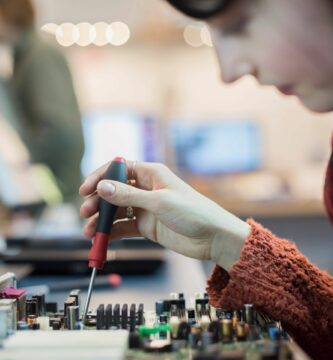 computer repair shop a woman using an electronic screwdriver tool on a computer circuit board 546999517 57a25f453df78c32762ad89e be9dc32d96f14b1196bed2ccbb07d88d