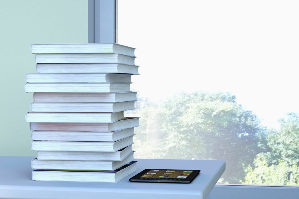 e reader and stack of book lying on a table in front of a window 3d rendering 522936559 579180c75f9b58cdf330e41d 5c76d95e46e0fb0001d83c81