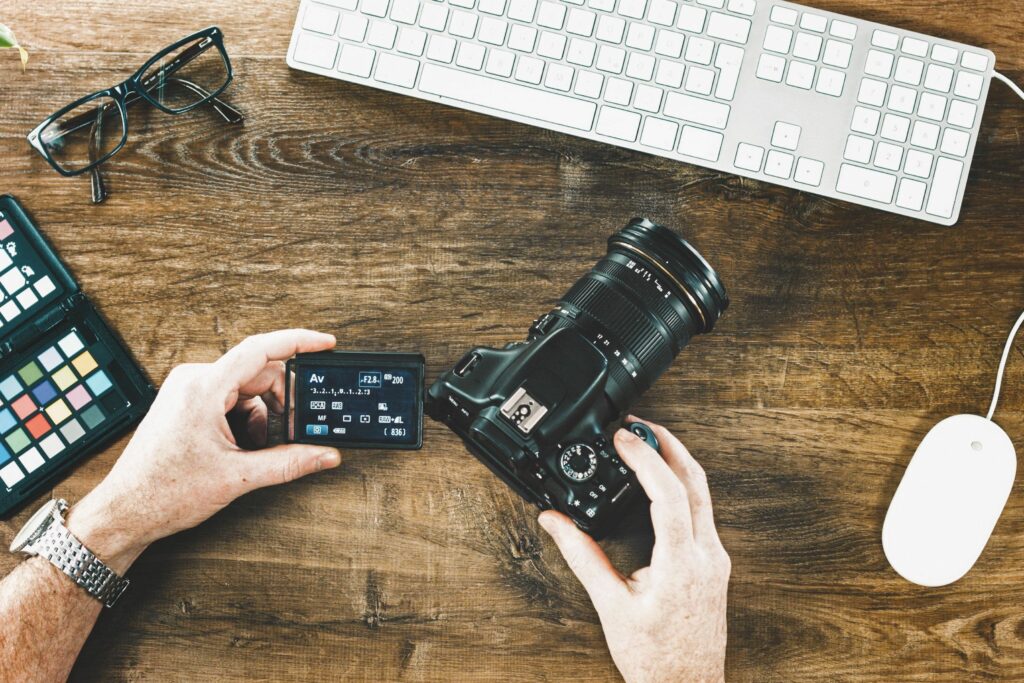 high angle view of man holding camera at table 877994880 5b1e840e3037130036d9bc07 ad7221e1c34b4f9db5991a98ddc0a775