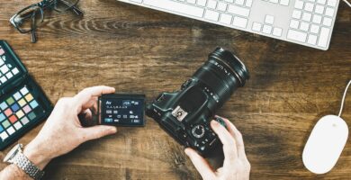 high angle view of man holding camera at table 877994880 5b1e840e3037130036d9bc07 ad7221e1c34b4f9db5991a98ddc0a775