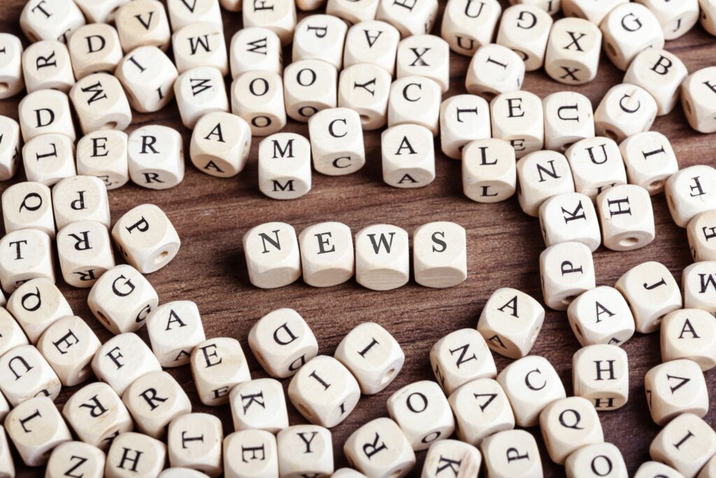 high angle view of news text arranged with alphabet blocks on wooden table 746119745 5bdf213bc9e77c0051ac3ce2