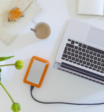 home office high angle view or directly above view of laptop with external hard disk drive and flower vase on white table 637423280 5b0424891d640400361162ba