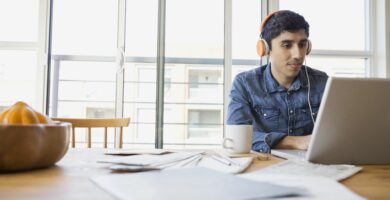 man in headphones using laptop at table 522795487 5b86f7b946e0fb005028ee99