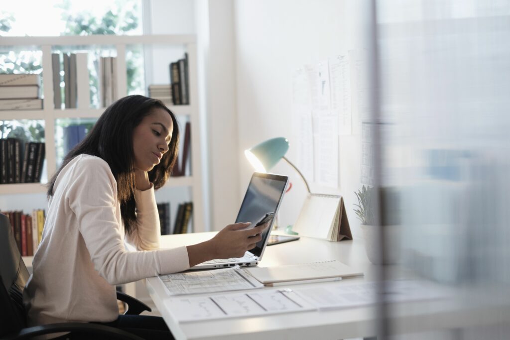 mixed race businesswoman using cell phone 606353283 5b216086eb97de0036cb09f3