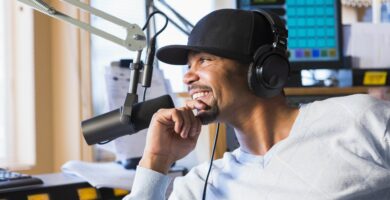 mixed race disc jockey smiling in studio 182939435 57f51f495f9b586c3545ff73
