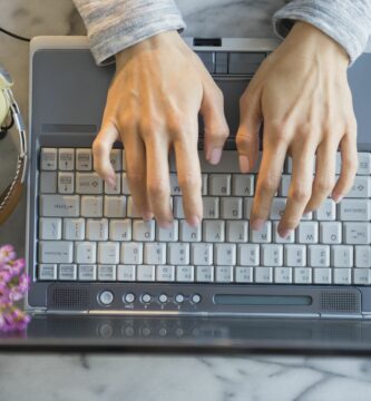 mixed race woman using laptop at table 591404029 5a8d90eb642dca0036707cca