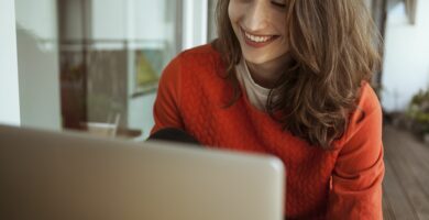 smiling young woman using laptop on balcony 900250042 5bfdc2d946e0fb0026a708d5