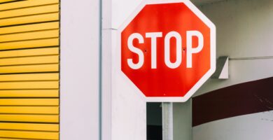 stop sign against building 752178835 5bf02fd4c9e77c0051d06485