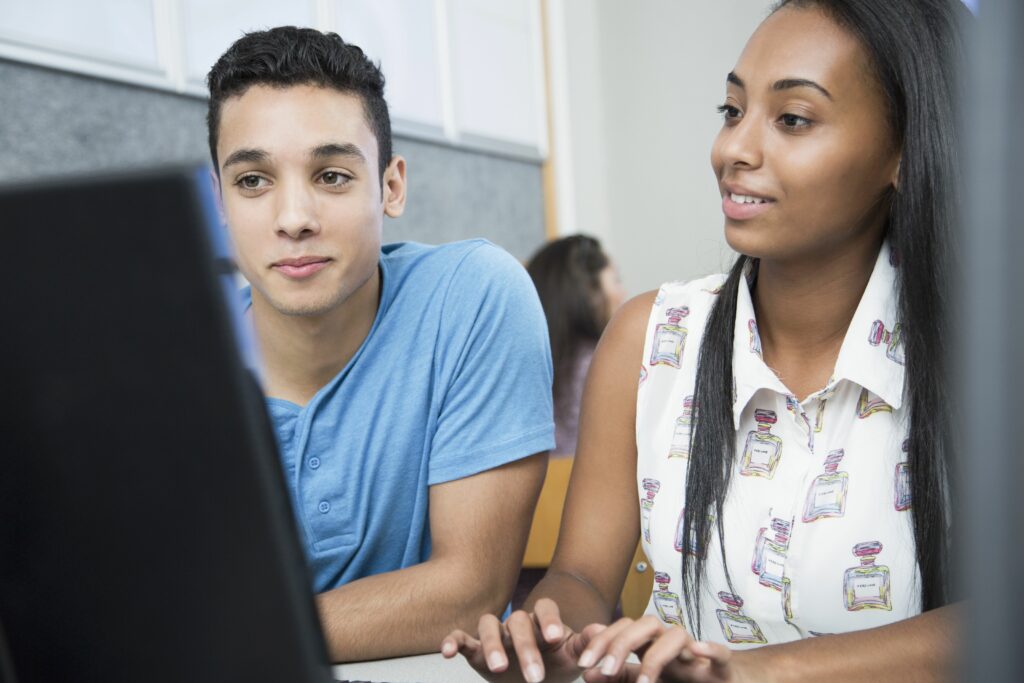 two teenagers working on computer in high school class 592236409 5a2564da0d327a00379e82f4