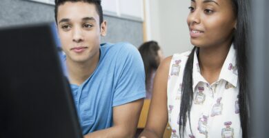 two teenagers working on computer in high school class 592236409 5a2564da0d327a00379e82f4