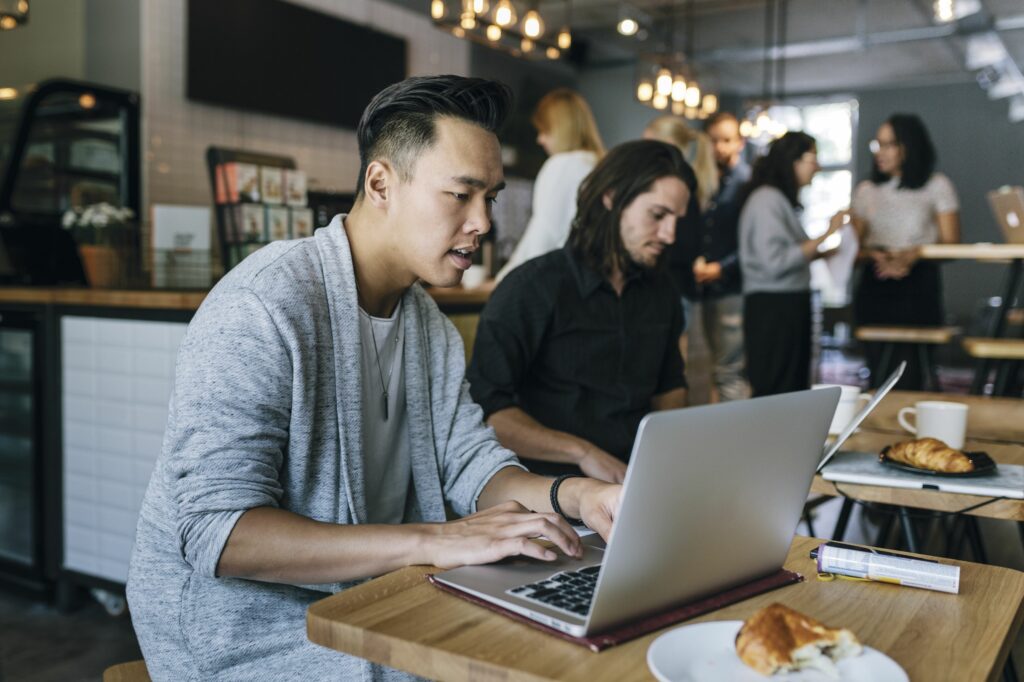 two young colleagues working on laptops in business cafe 683807906 5a39d082c7822d0037ec9ac2