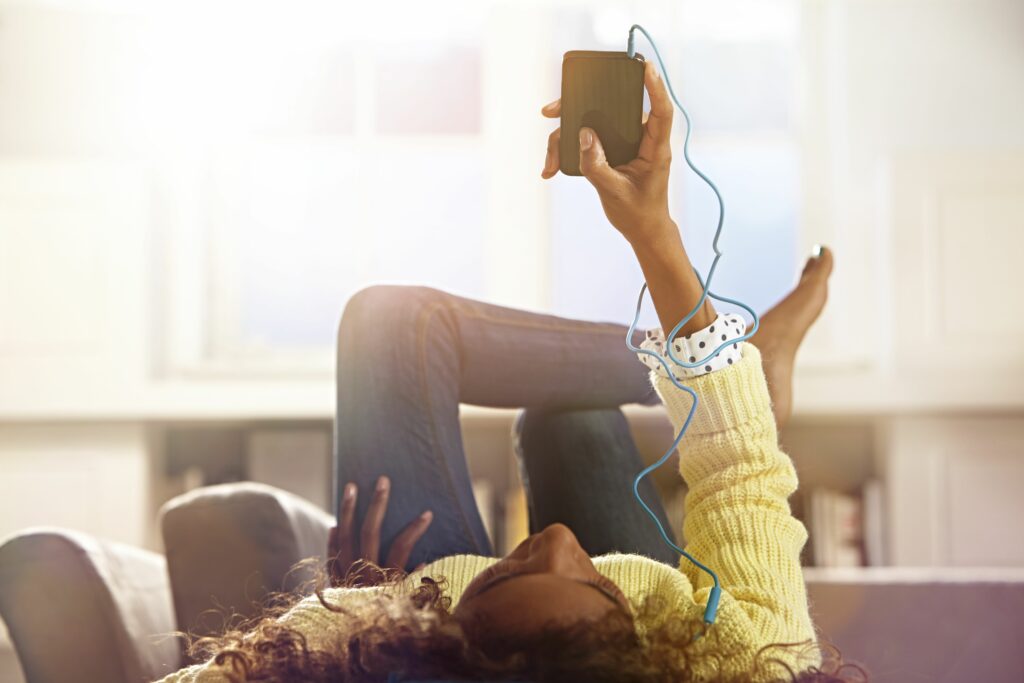 woman relaxing at home listening to her phone 479977911 5b3e3217c9e77c003701b598