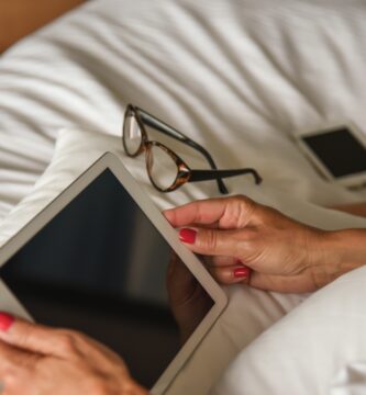 woman using digital tablet on bed 760250981 5b8460bec9e77c005744bba4