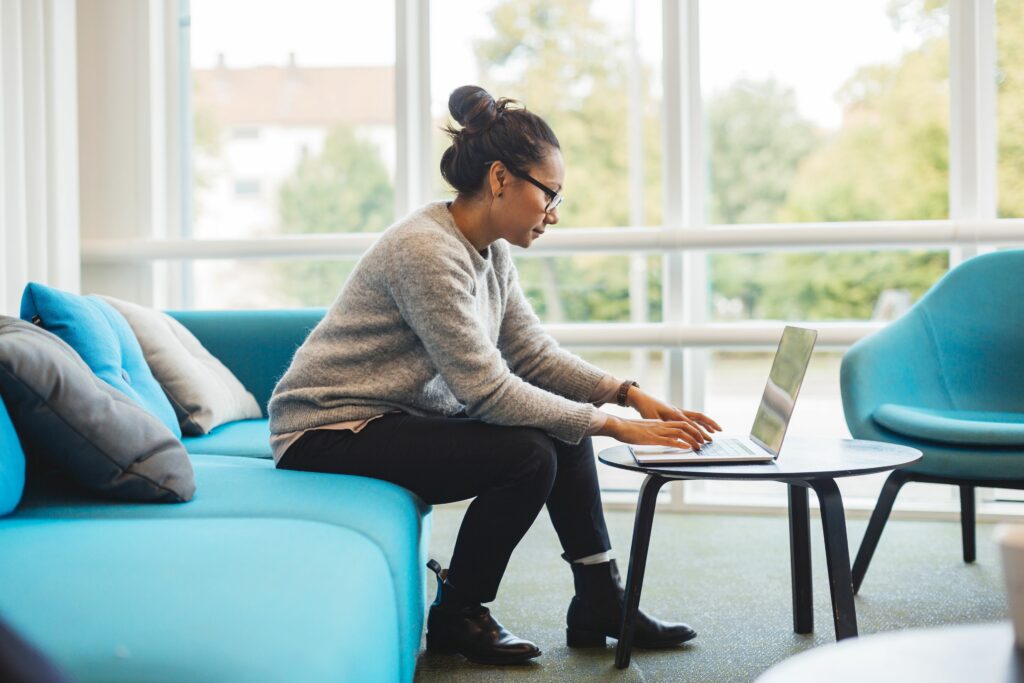 woman using laptop in living room 925367278 5c0c116ac9e77c00018b4e57