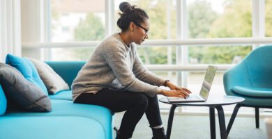 woman using laptop in living room 925367278 5c4624cdc9e77c00014f2004