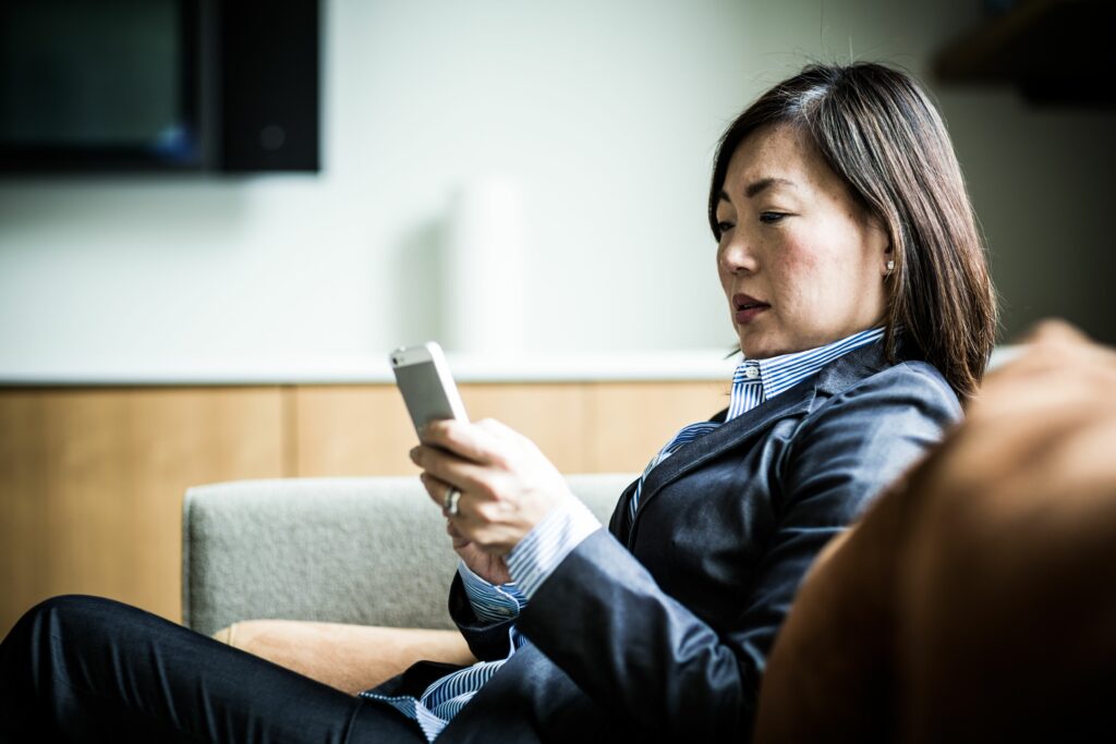 woman using smartphone on couch 485987951 57a22b015f9b589aa9079532