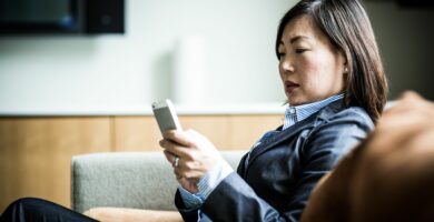 woman using smartphone on couch 485987951 57a22b015f9b589aa9079532