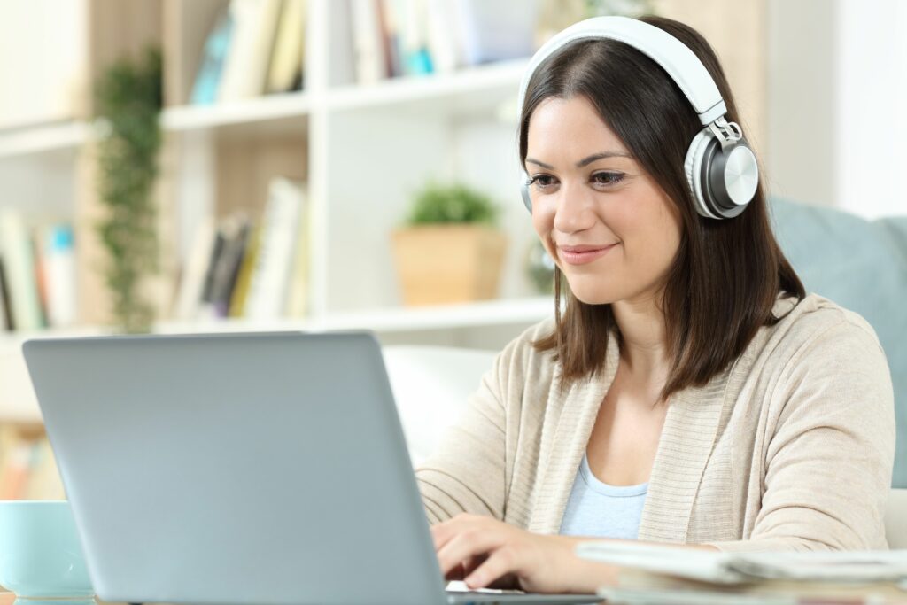 woman with headphones and laptop at home 1280611332 e84e8ba7fbea449b82ced11c31cf7160